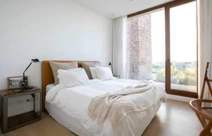 Dormitorio moderno minimalista con grandes ventanales y luz natural — proyecto Gray Rock, por BAS Y GARCIA , en Escobar